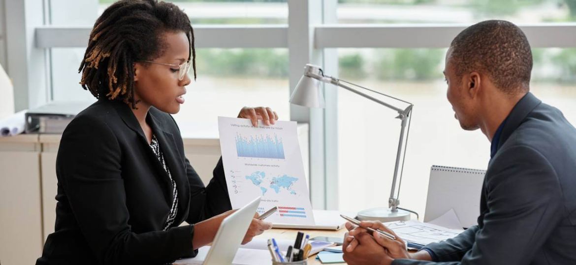 side-view-businesswoman-showing-analytical-charts-her-male-coworker