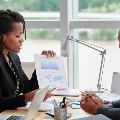 side-view-businesswoman-showing-analytical-charts-her-male-coworker